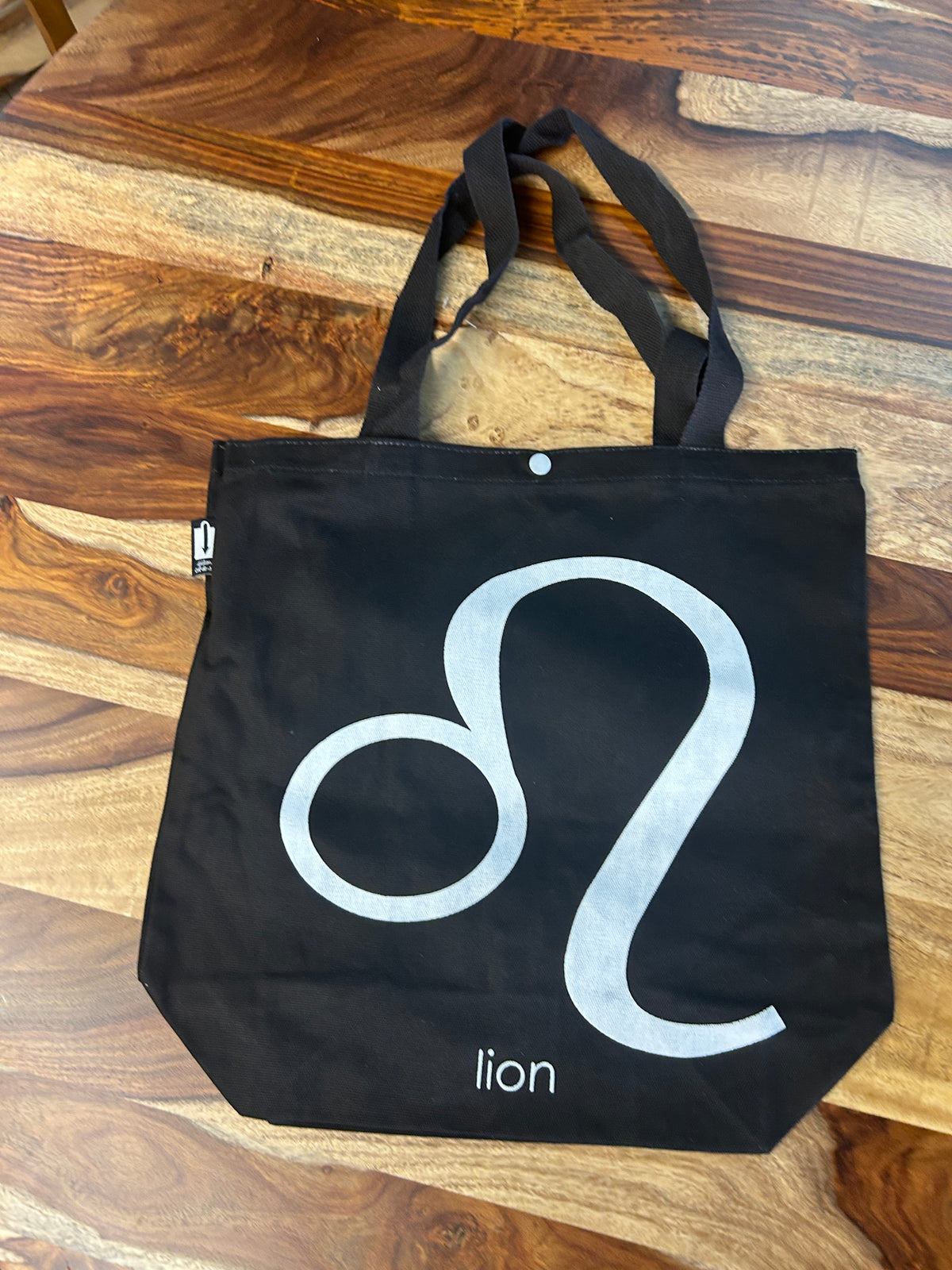 Tote bag noir au symbole du Lion imprimé en blanc